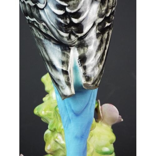 166 - Beswick Budgie, Model number 1214. needs repair to wingtips and flower petals. Worth restoring.