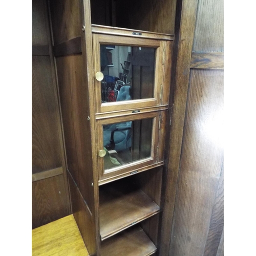 55 - Nicely made dark oak medium sized wardrobe decorated with panels and fluted columns. Exposed decorat... 