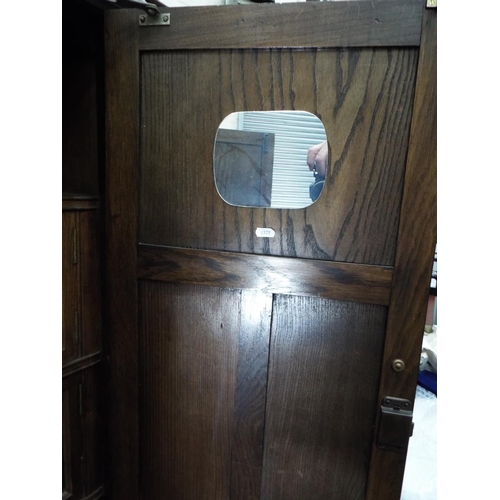 55 - Nicely made dark oak medium sized wardrobe decorated with panels and fluted columns. Exposed decorat... 