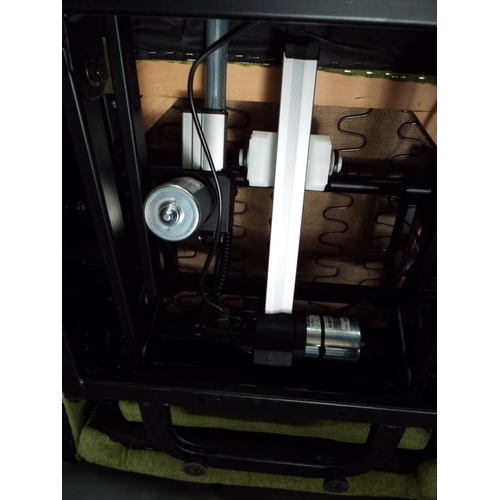 56 - Electric twin motor rise and recline chair upholstered in green fabric. Working order.