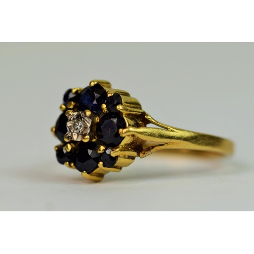 314 - 18ct Yellow Gold ring set with a central Diamond with Sapphire surround. Finger size 'Q'   4.3g