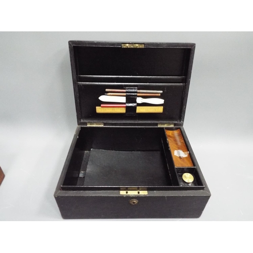 292 - A early edwardian writing box with original inkwell and writing aids.