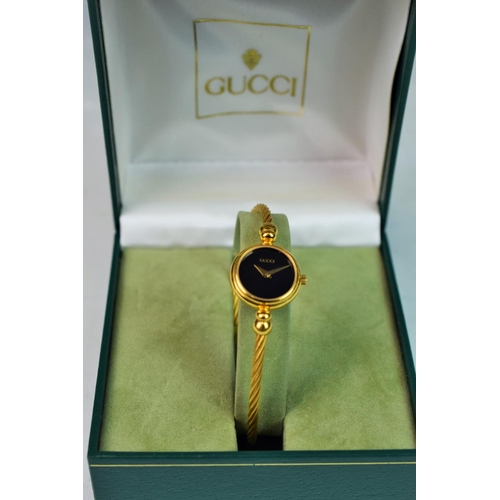 376A - Gucci ladies quartz watch with torque bracelet strap. original box and sleeve.