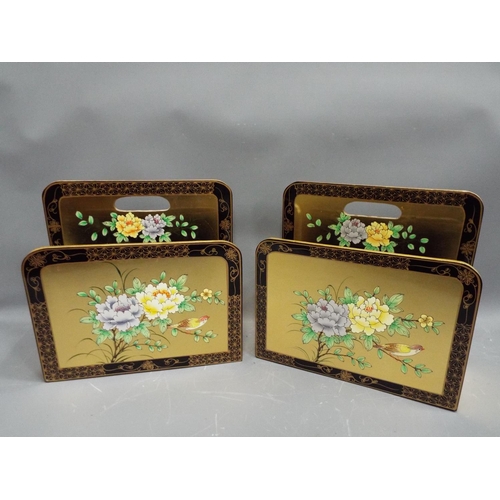 652 - A Pair of matching magazine racks in gold with floral design.