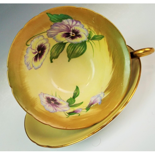 23 - A Shelley cup and saucer the cup is decorated to the inside with Pansies