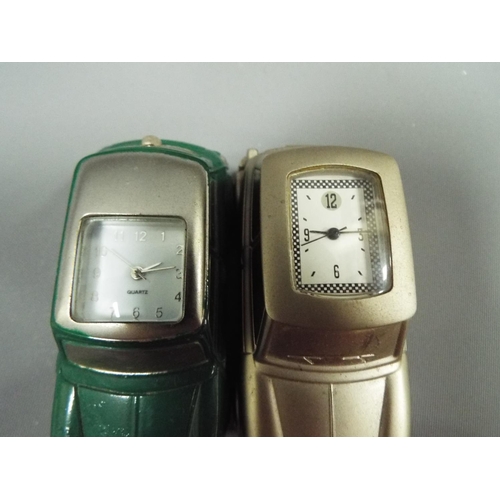 403 - Two Die cast metal minis with quartz clocks set into the roofs. Will need batteries to run. See phot... 