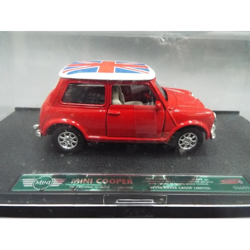 405 - New Ray die cast model of a Mini cooper set in a perspex box together with a Corgi Italian Job, thre... 