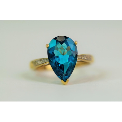 508 - 9ct yellow Gold Ring set with a large Peardrop Topaz of 12 x 8 mm (3cts) White Sapphires to shoulder... 