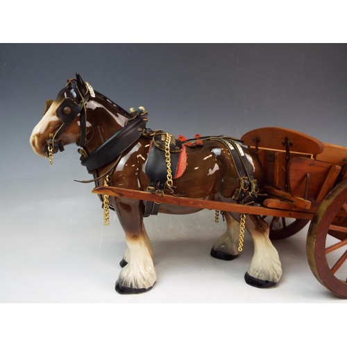 141 - A Large ceramic shire horse and wooden cart , the cart measures 20