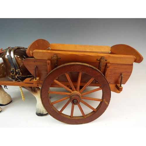 141 - A Large ceramic shire horse and wooden cart , the cart measures 20