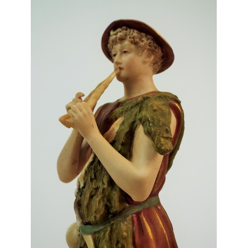 169 - Royal Dux bisque figurine of a shepherd playing a flute. 12.5