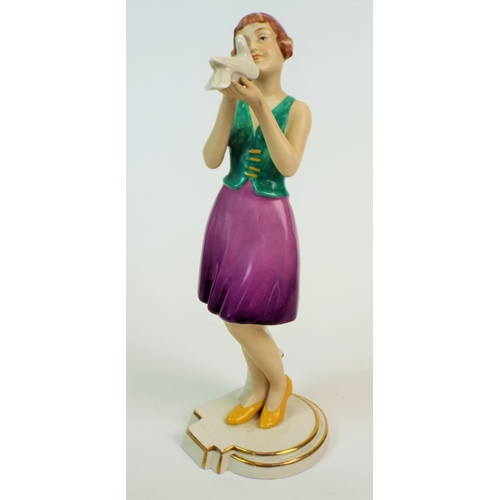 173 - Royal dux figurine of a art deco lady standing holding a dove, 11.5