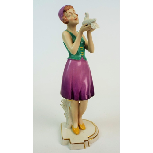 173 - Royal dux figurine of a art deco lady standing holding a dove, 11.5