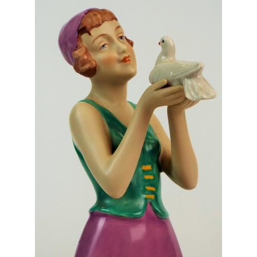 173 - Royal dux figurine of a art deco lady standing holding a dove, 11.5