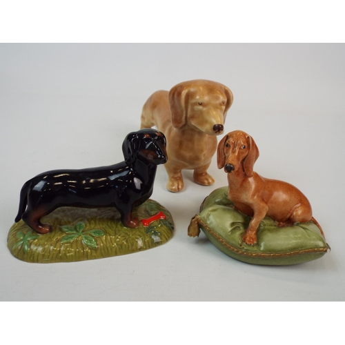 230 - 3 Dachshund Figurines by Royal Doulton, Sylvac & Capodimonte. ( Capodimonte one has minor chips to c... 