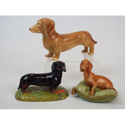 230 - 3 Dachshund Figurines by Royal Doulton, Sylvac & Capodimonte. ( Capodimonte one has minor chips to c... 