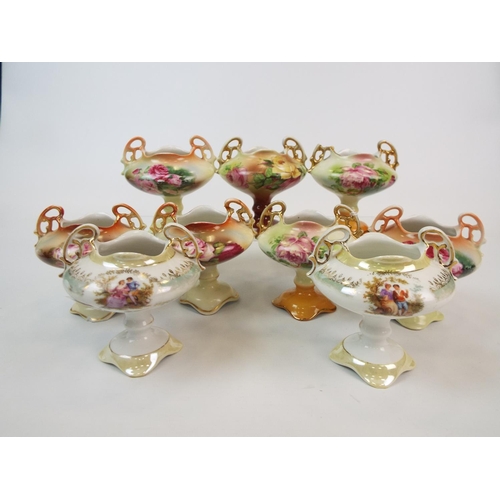 243 - 9 Continental porcelain mini pedastal vases mainly with floral decoration.