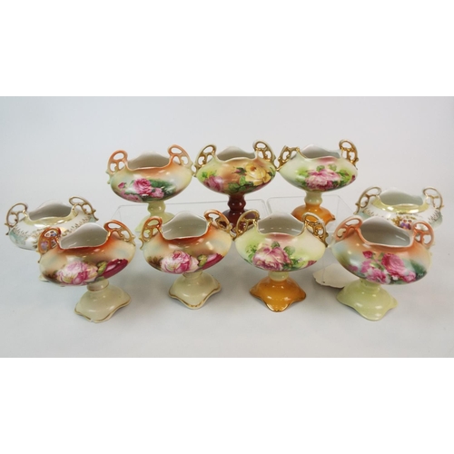 243 - 9 Continental porcelain mini pedastal vases mainly with floral decoration.