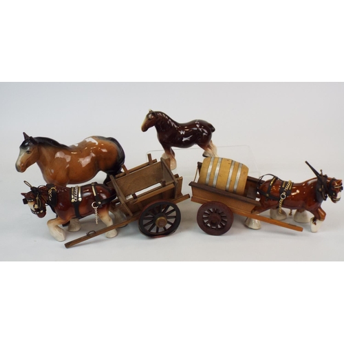 381 - Four ceramic shire horses 2 with wooden carts ( 1 horse has a chip to one ear.)