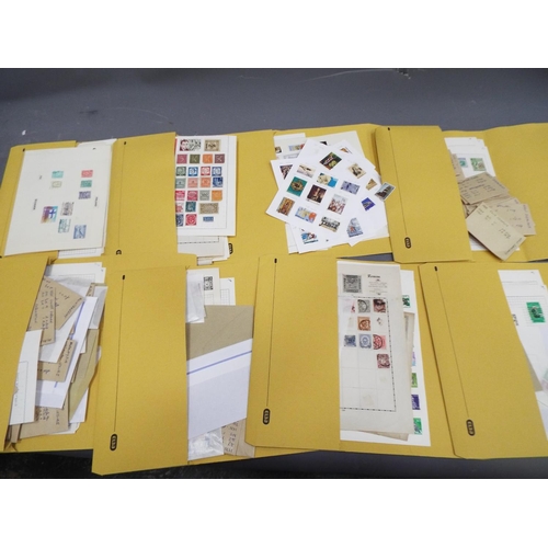 329 - Eight folders of loose and graded stamps plus album pages. See photos