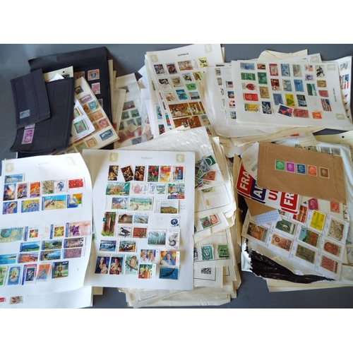 332 - Large selection of world stamps, loose and on pages.