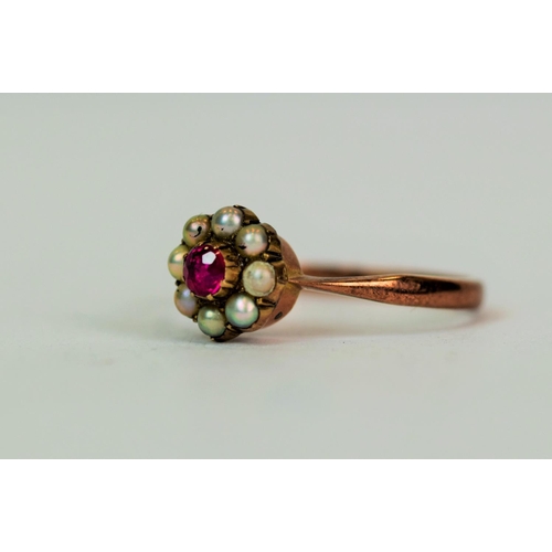 562 - 9ct Yellow Gold ring set with a central 3mm Ruby and surrounded by a halo of Eight Pearls.  Finger s... 