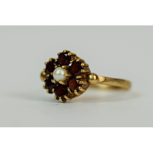 574 - 9ct Yellow Gold ring set with a central Pearl with six Garnet Halo.  Finger size Q'   2.6g