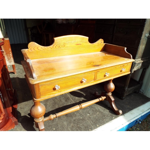 921 - Antique pine reception table with two drawers which have crystal handles.  Wide turned supports and ... 