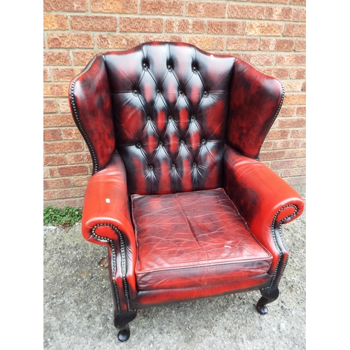 943 - Leather Chesterfield wing chair finished in Oxblood. Very good condition. See photos.