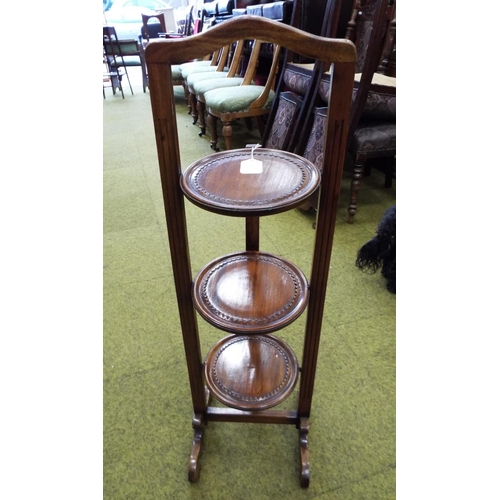 973 - Folding three tier mahogany cake stand in good condition. See photos.