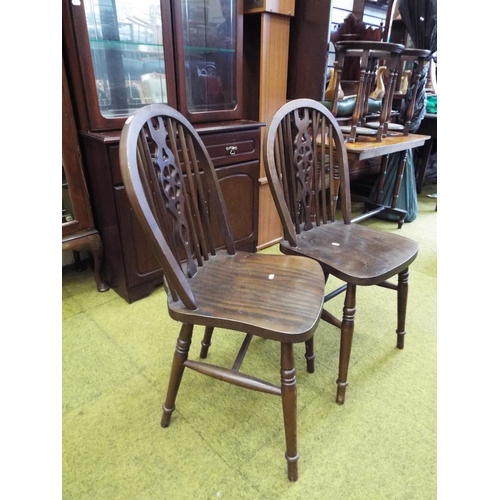 988 - Two darkwood wheel backed parlour/dining chairs. See photos.