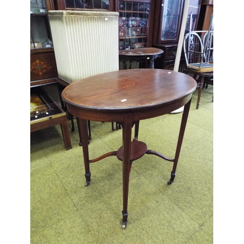 998 - Handsome Edwardian era oval occasional table with shelf under. Tapered legs on original castors. H:2... 