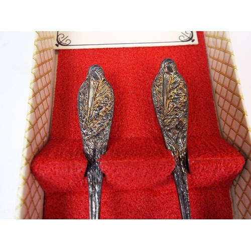 787 - A Silver plated spoon and fork set with stork handles.