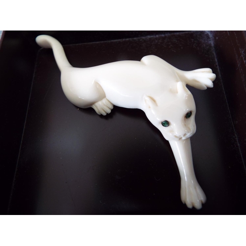 832 - Beautiful lucite deco brooch in the form of a panther with green stone eyes.