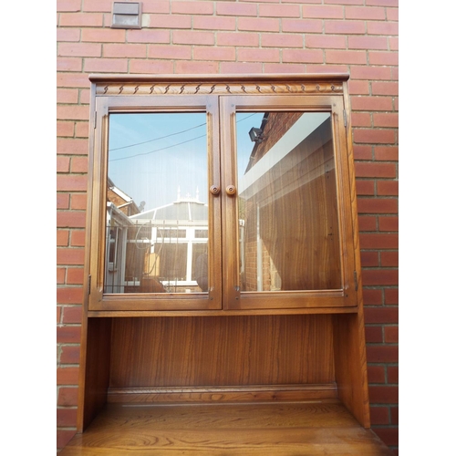 1032 - Ercol Cupboard with two doors and glazed doors above. Comes in two pieces for ease of movement. H:77... 