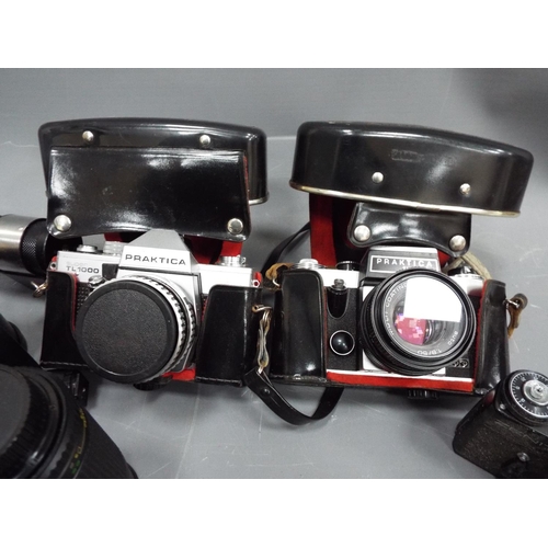 1145 - Selection of vintage cameras lenses and flashes.