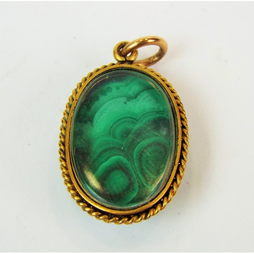 547a - Victorian era Malachite set mourning pendant with clear glass back mounted in unmarked yellow gold w... 