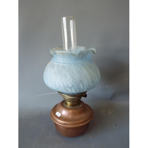 1344 - A oil lamp with frosted glass shade complete with decorative cast iron lamp stand. See photos.