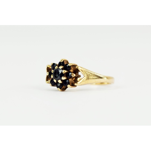 102 - 9ct Yellow Gold Sapphire set ring in a Flower pattern. Finger size 'N-5'   2.7g