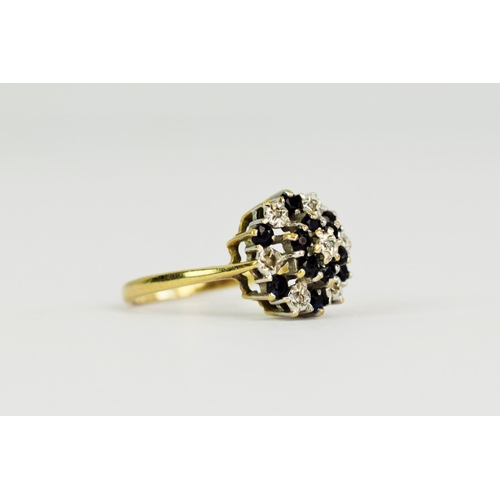 103 - 9ct Yellow Gold Diamond and Sapphire set ring in a flower pattern. Finger size 'M'   2.4g