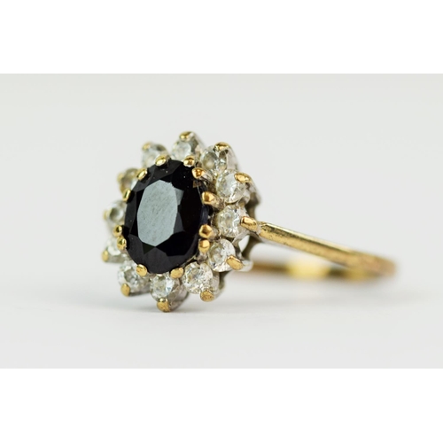 113 - 9ct Yellow Gold ring set with a large central Sapphire with CZ surround. Finger size 'Q-5'  2.5g