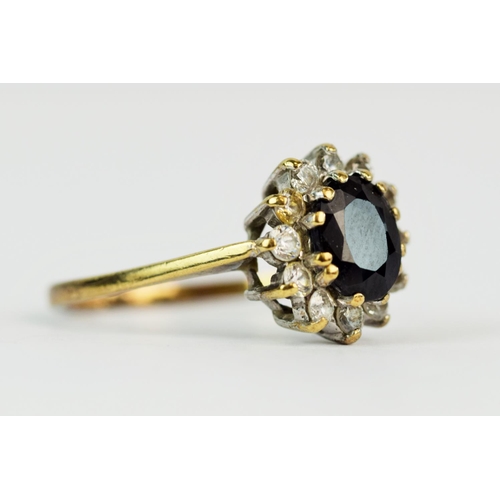 113 - 9ct Yellow Gold ring set with a large central Sapphire with CZ surround. Finger size 'Q-5'  2.5g