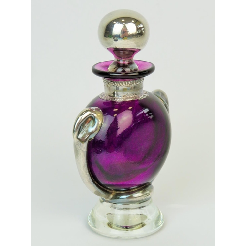 180 - Amethyst glass scent bottle complimented by hallmarked silver decoration. Hallmarked for Sheffield 1... 