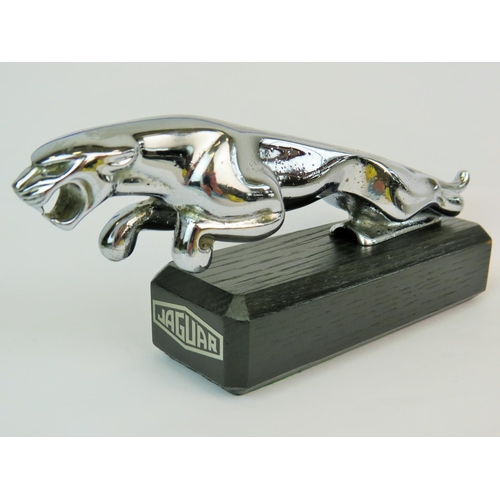 191 - Chrome Jaguar leaper bonnet mascot as a paperweight, properly mounted on an ebonised wooden base wit... 