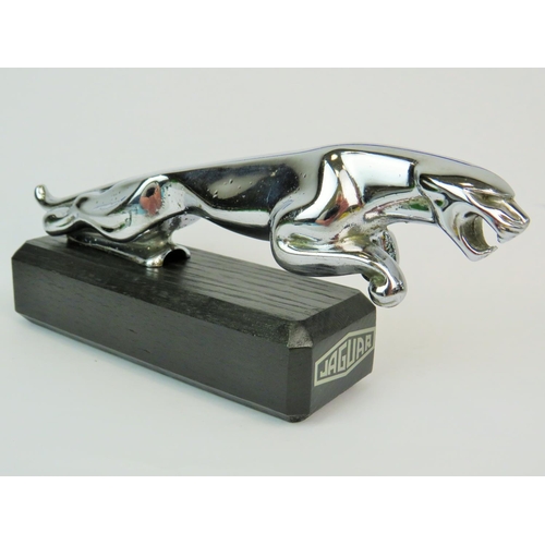 191 - Chrome Jaguar leaper bonnet mascot as a paperweight, properly mounted on an ebonised wooden base wit... 