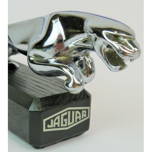 191 - Chrome Jaguar leaper bonnet mascot as a paperweight, properly mounted on an ebonised wooden base wit... 