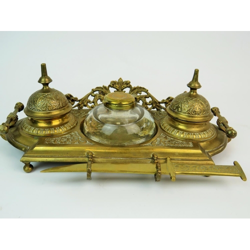 200 - Pierced brass, middle eastern style desk set with scimitar letter opener. Glass central inkwell with... 