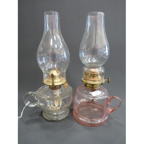 307 - Antique hand held oil lamp with clear reservoir & chimney plus one other with peach glass reservoir.... 