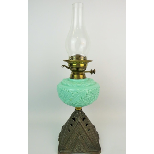 366 - Pretty oil lamp with pierced cast metal base, Green glass reservoir decorated with embossed leaves, ... 