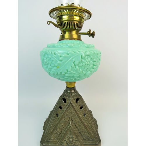 366 - Pretty oil lamp with pierced cast metal base, Green glass reservoir decorated with embossed leaves, ... 